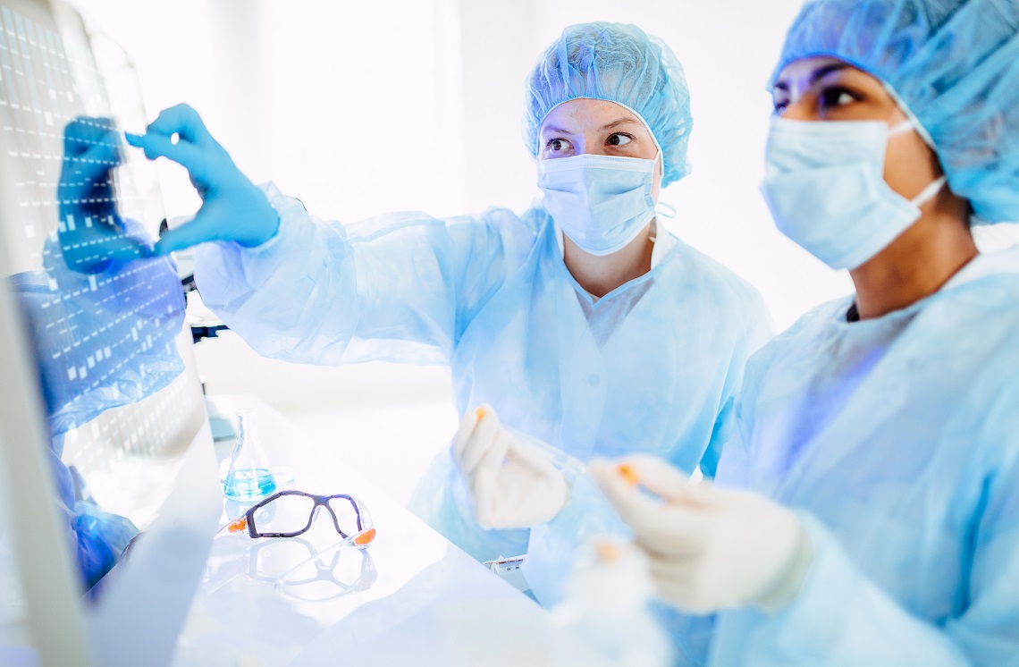 Scientists working in the laboratory, wearing full protective suit